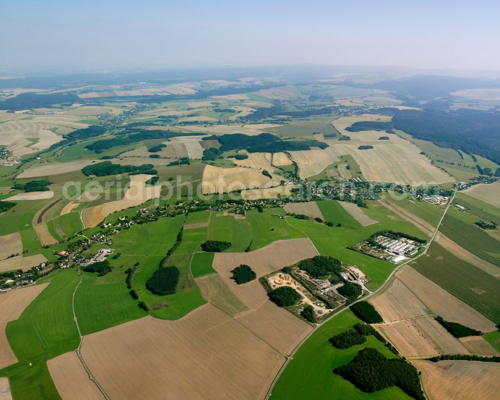 Burkersdorf from above - Agricultural land and field boundaries surround the settlement area of the village in Burkersdorf in the state Saxony, Germany