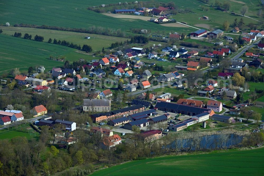 Aerial image Crussow - Agricultural land and field boundaries surround the settlement area of the village in Crussow in the state Brandenburg, Germany