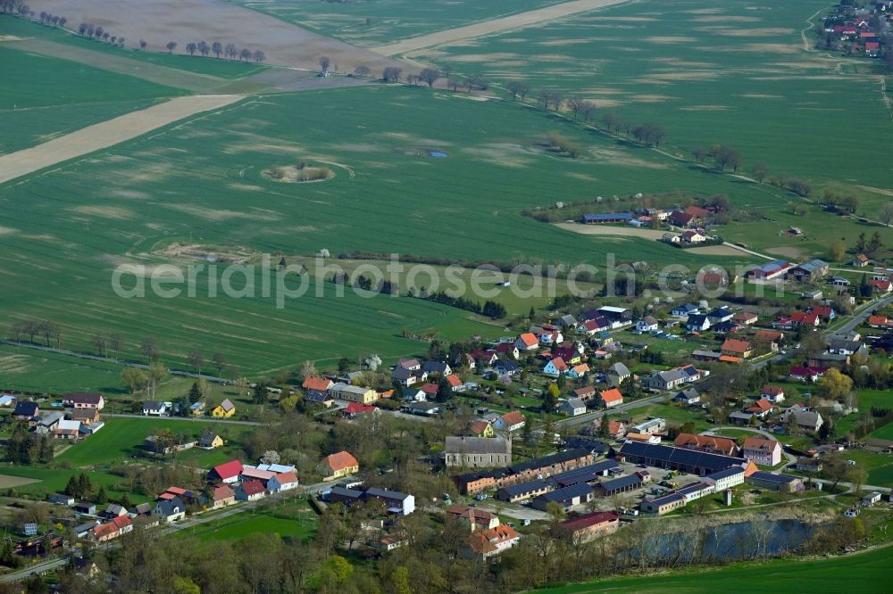 Aerial photograph Crussow - Agricultural land and field boundaries surround the settlement area of the village in Crussow in the state Brandenburg, Germany