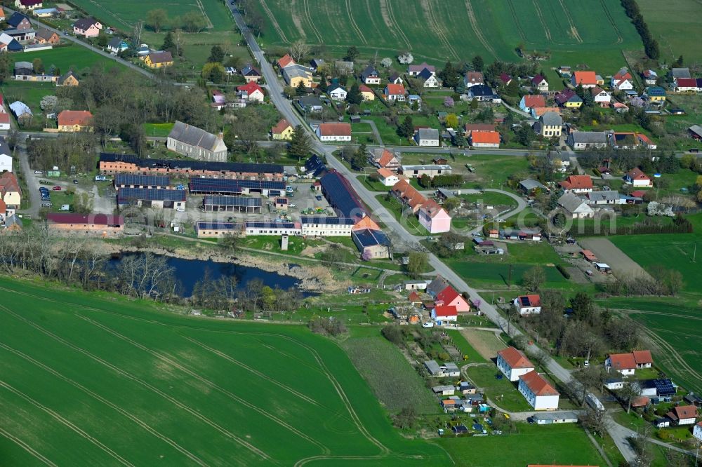 Crussow from above - Agricultural land and field boundaries surround the settlement area of the village in Crussow in the state Brandenburg, Germany