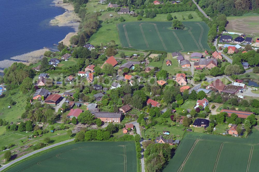 Dargow from the bird's eye view: Agricultural land and field boundaries surround the settlement area of the village in Dargow in the state Schleswig-Holstein, Germany
