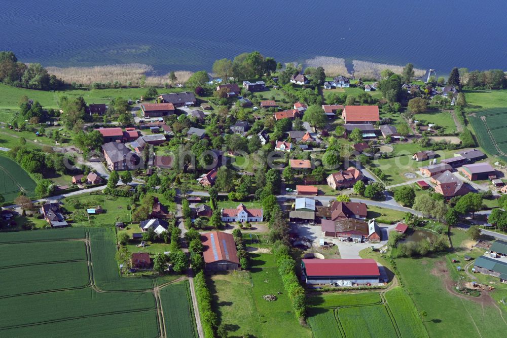 Dargow from above - Agricultural land and field boundaries surround the settlement area of the village in Dargow in the state Schleswig-Holstein, Germany