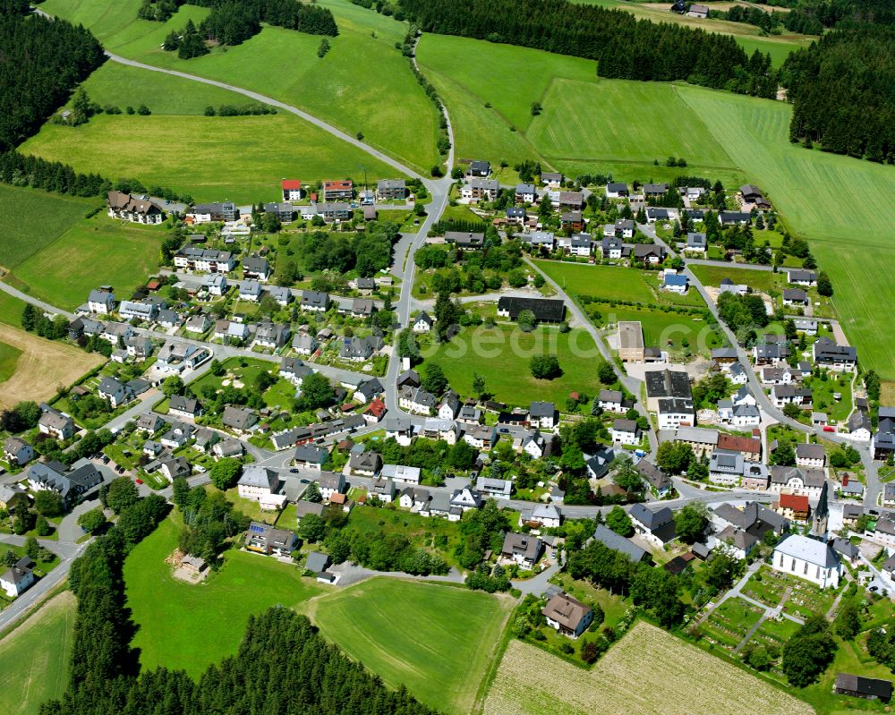 Döbra from above - Agricultural land and field boundaries surround the settlement area of the village in Döbra in the state Bavaria, Germany