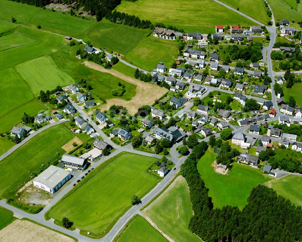 Döbra from the bird's eye view: Agricultural land and field boundaries surround the settlement area of the village in Döbra in the state Bavaria, Germany