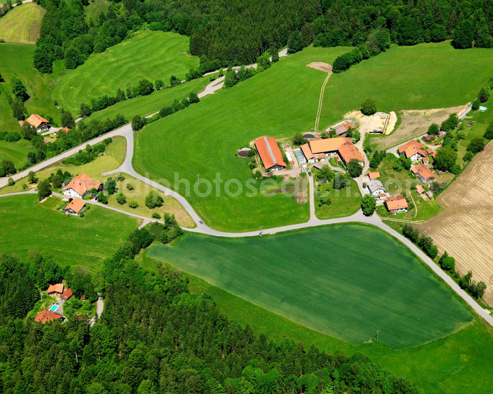 Ödhof from above - Agricultural land and field boundaries surround the settlement area of the village in Ödhof in the state Bavaria, Germany