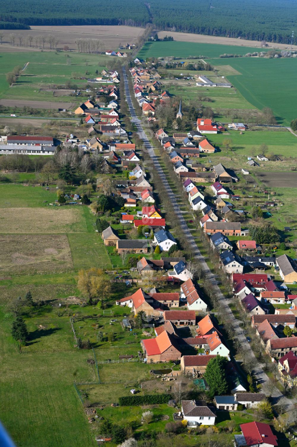 Dierberg from above - Agricultural land and field boundaries surround the settlement area of the village in Dierberg in the state Brandenburg, Germany