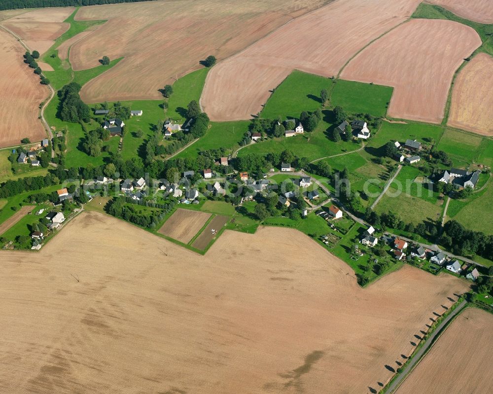 Dittersbach from above - Agricultural land and field boundaries surround the settlement area of the village in Dittersbach in the state Saxony, Germany