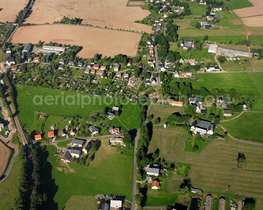 Dittersbach from the bird's eye view: Agricultural land and field boundaries surround the settlement area of the village in Dittersbach in the state Saxony, Germany