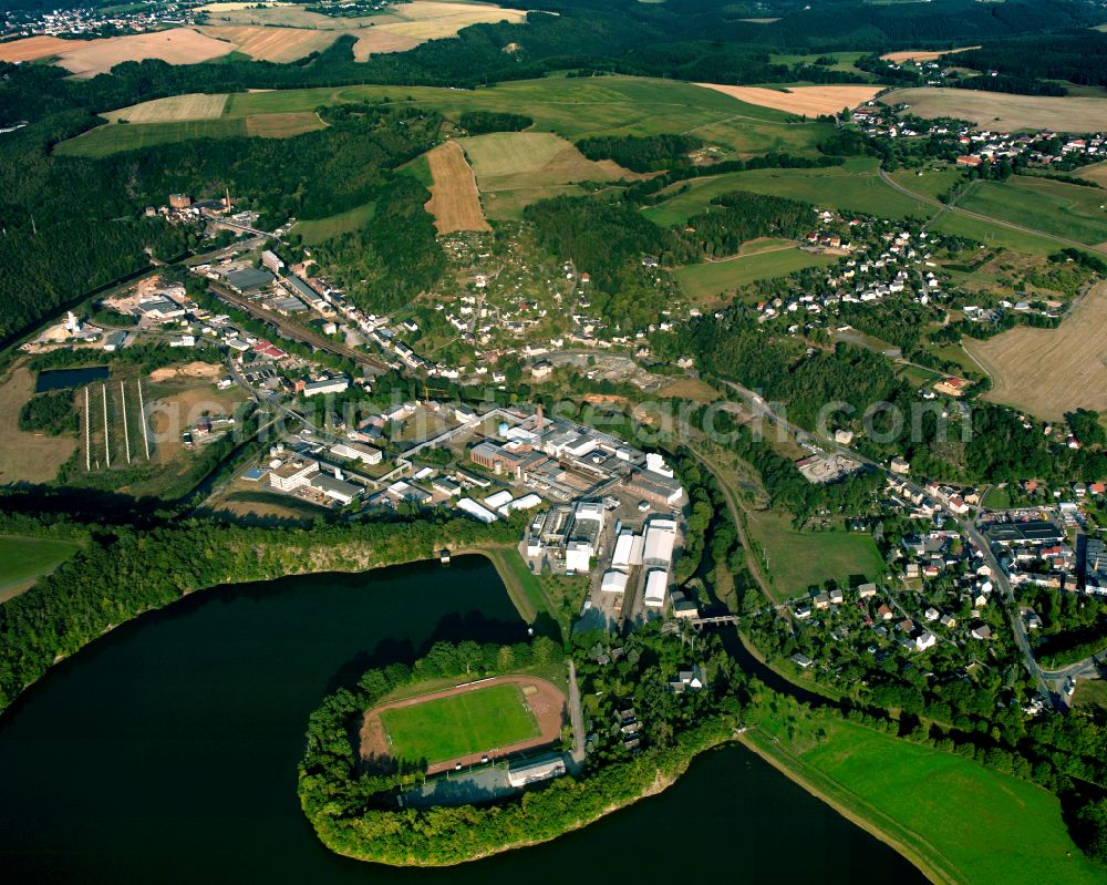 Dölau from above - Agricultural land and field boundaries surround the settlement area of the village in Dölau in the state Thuringia, Germany