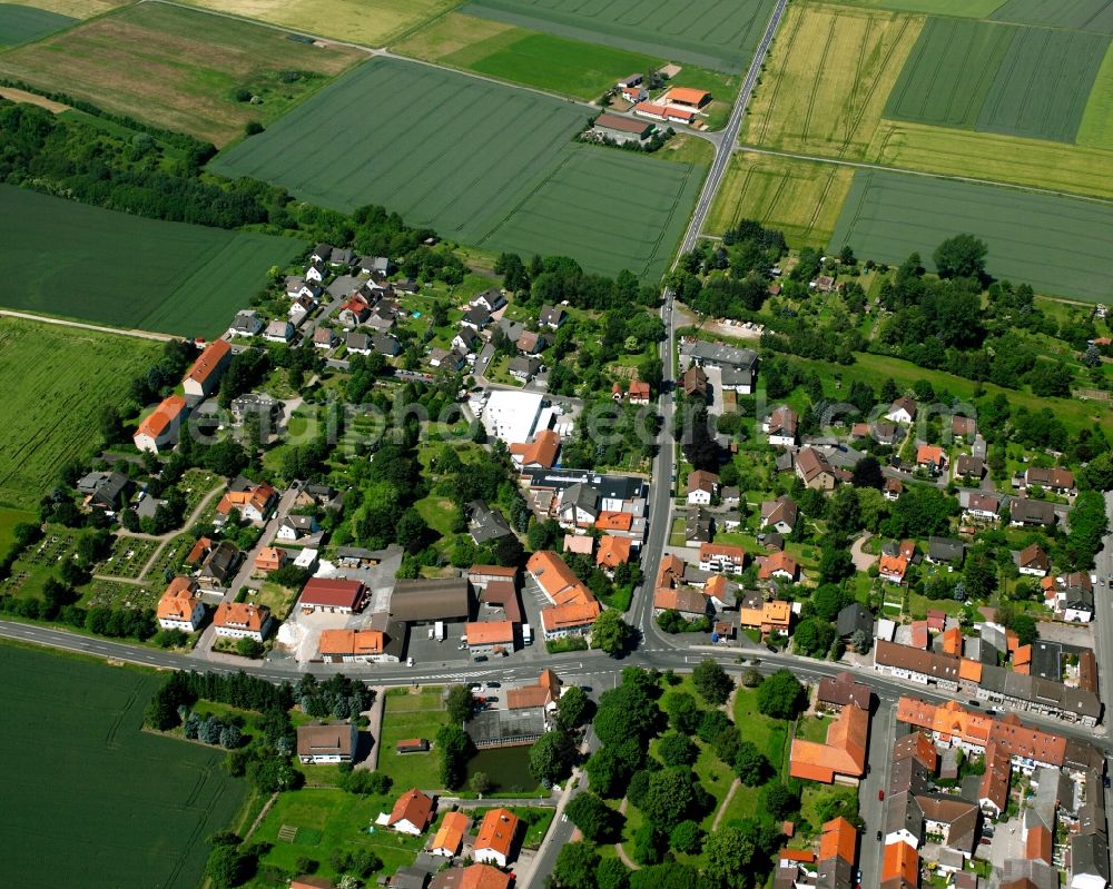 Dransfeld from the bird's eye view: Agricultural land and field boundaries surround the settlement area of the village in Dransfeld in the state Lower Saxony, Germany