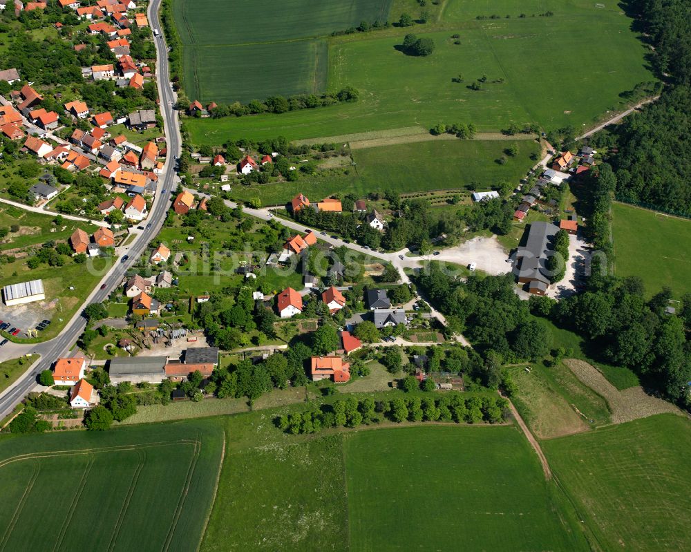 Drübeck from above - Agricultural land and field boundaries surround the settlement area of the village in Drübeck in the state Saxony-Anhalt, Germany
