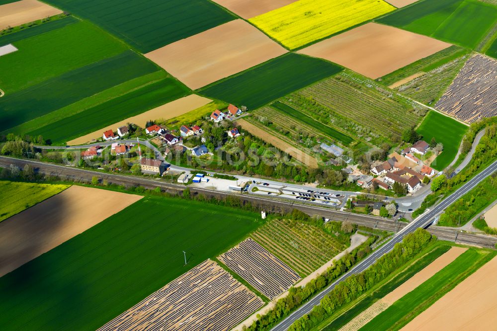 Effeldorf from above - Agricultural land and field boundaries surround the settlement area of the village in Effeldorf in the state Bavaria, Germany