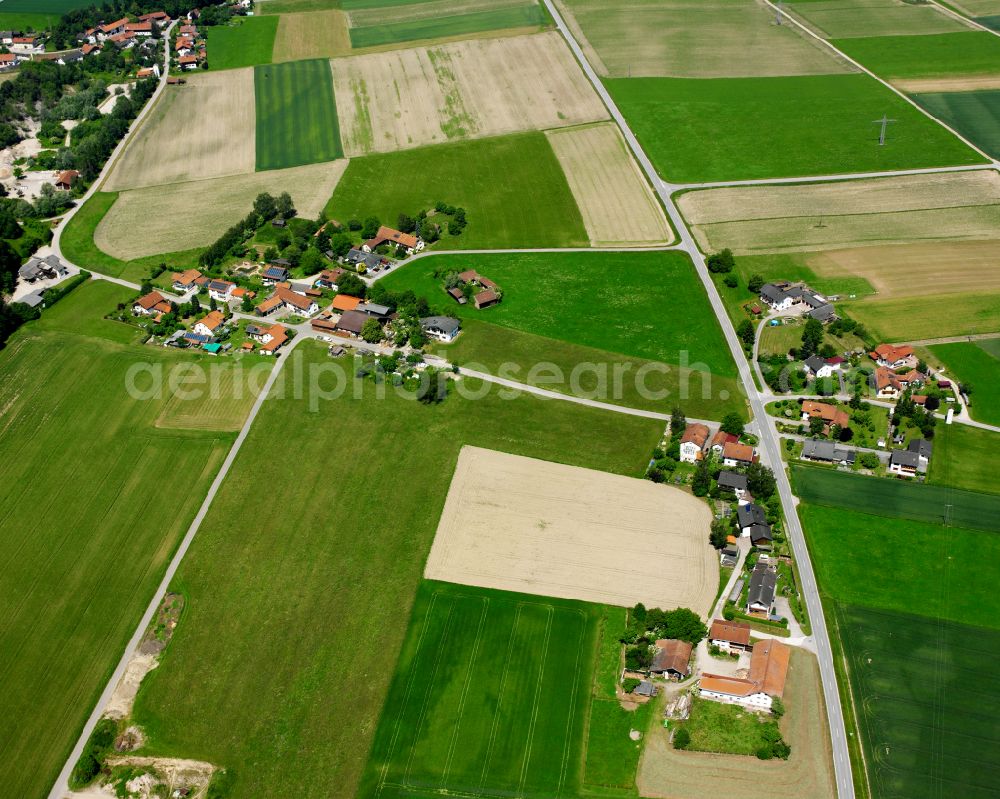 Eisching from the bird's eye view: Agricultural land and field boundaries surround the settlement area of the village in Eisching in the state Bavaria, Germany