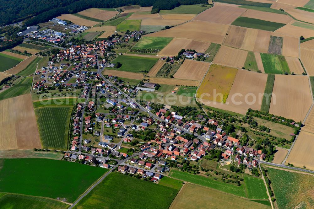 Erbshausen-Sulzwiesen from above - Agricultural land and field boundaries surround the settlement area of the village in Erbshausen-Sulzwiesen in the state Bavaria, Germany