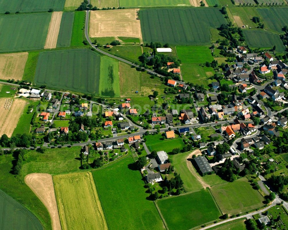 Escherode from above - Agricultural land and field boundaries surround the settlement area of the village in Escherode in the state Lower Saxony, Germany