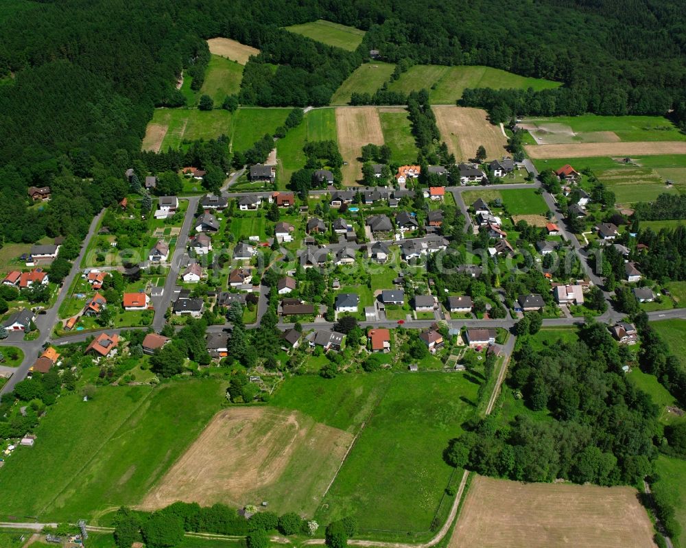 Aerial photograph Escherode - Agricultural land and field boundaries surround the settlement area of the village in Escherode in the state Lower Saxony, Germany