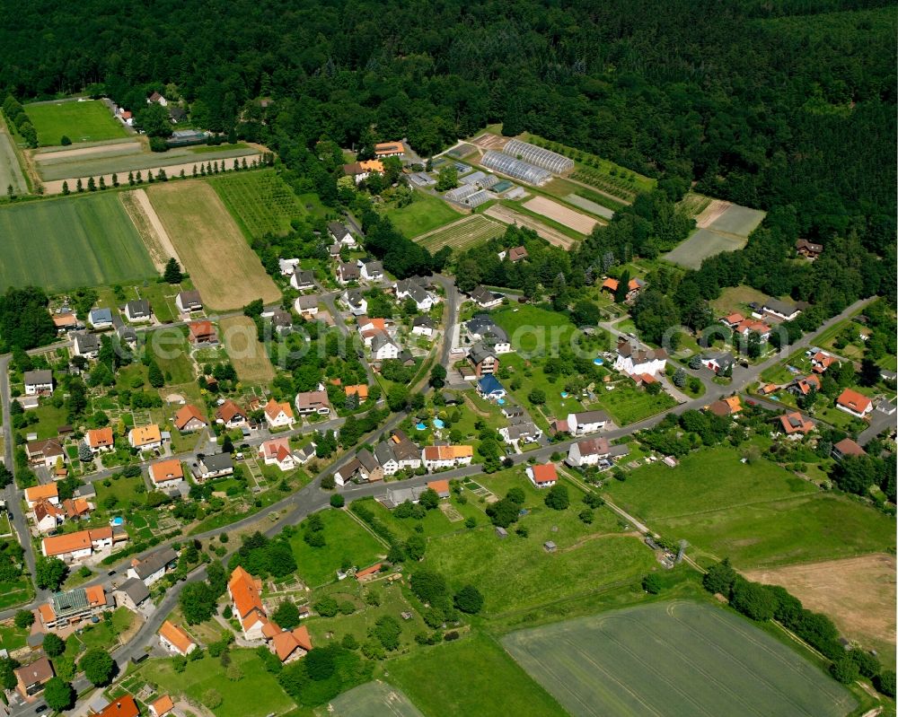 Escherode from above - Agricultural land and field boundaries surround the settlement area of the village in Escherode in the state Lower Saxony, Germany