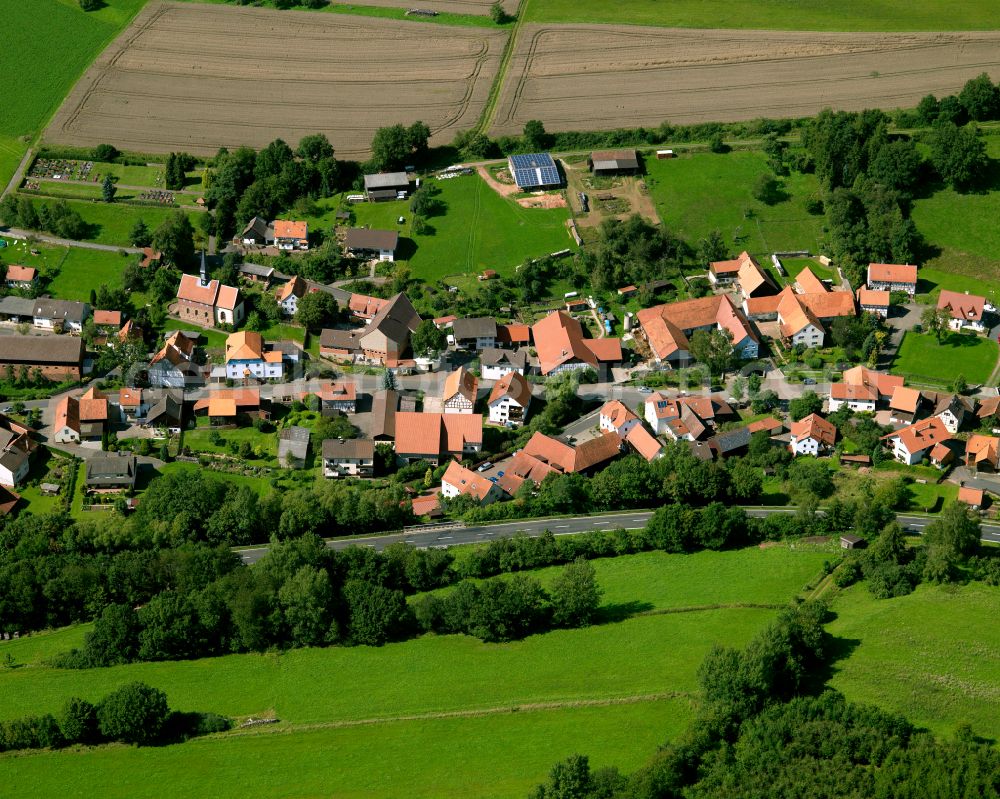 Aerial image Fraurombach - Agricultural land and field boundaries surround the settlement area of the village in Fraurombach in the state Hesse, Germany