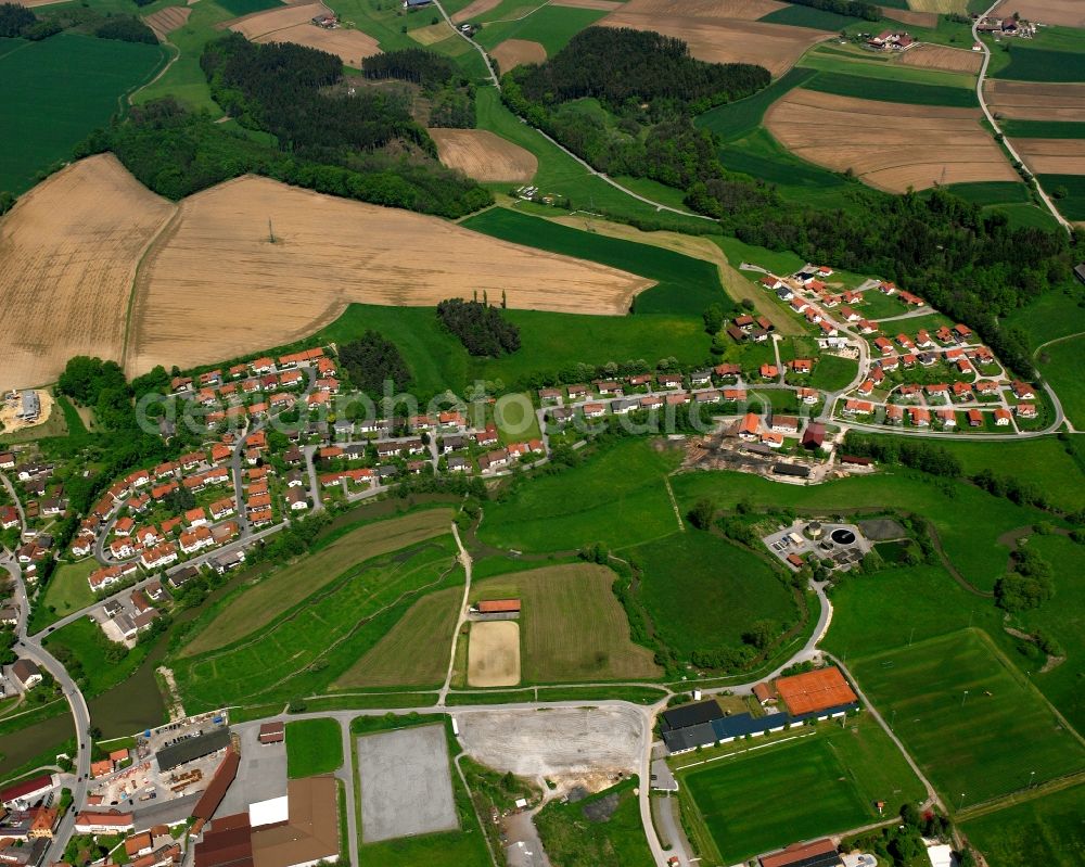Freising from the bird's eye view: Agricultural land and field boundaries surround the settlement area of the village in Freising in the state Bavaria, Germany