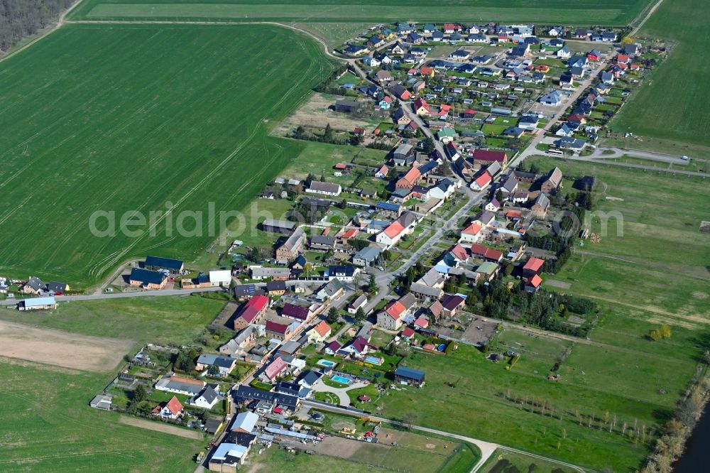 Gatow from the bird's eye view: Agricultural land and field boundaries surround the settlement area of the village in Gatow in the state Brandenburg, Germany