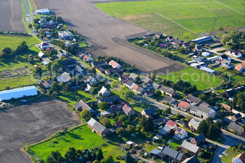 Glienicke from the bird's eye view: Agricultural land and field boundaries surround the settlement area of the village in Glienicke in the state Brandenburg, Germany