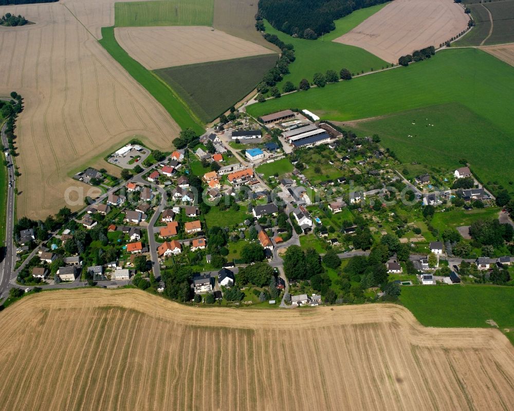 Grünberg from above - Agricultural land and field boundaries surround the settlement area of the village in Grünberg in the state Saxony, Germany