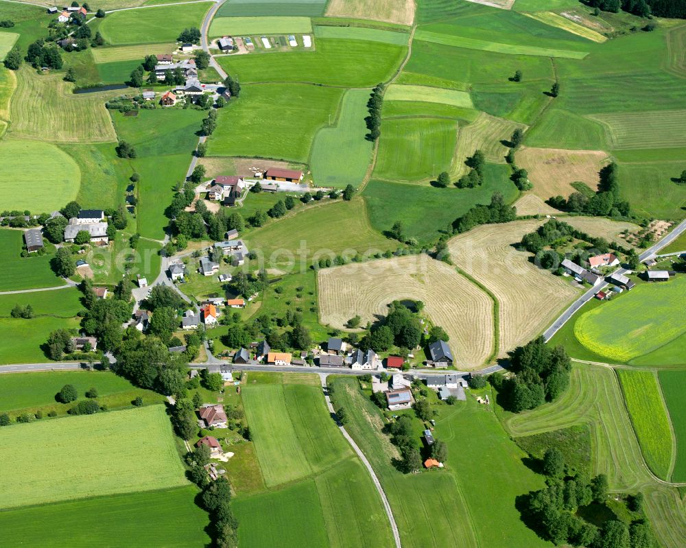 Aerial image Großenau - Agricultural land and field boundaries surround the settlement area of the village in Großenau in the state Bavaria, Germany
