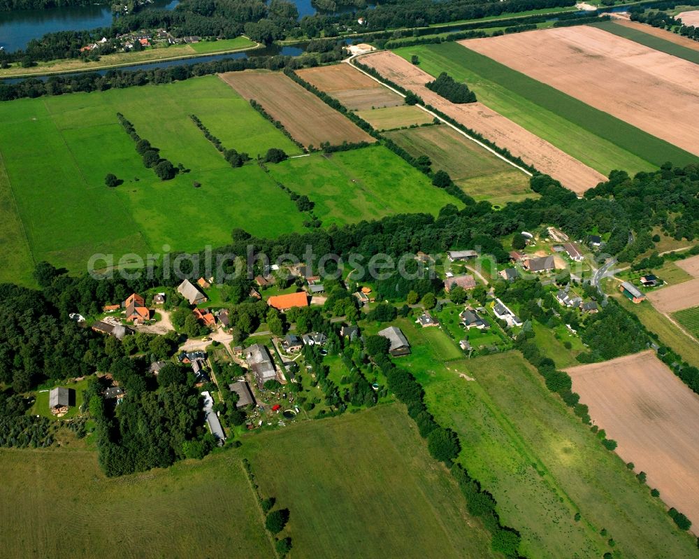 Göttin from above - Agricultural land and field boundaries surround the settlement area of the village in Göttin in the state Schleswig-Holstein, Germany