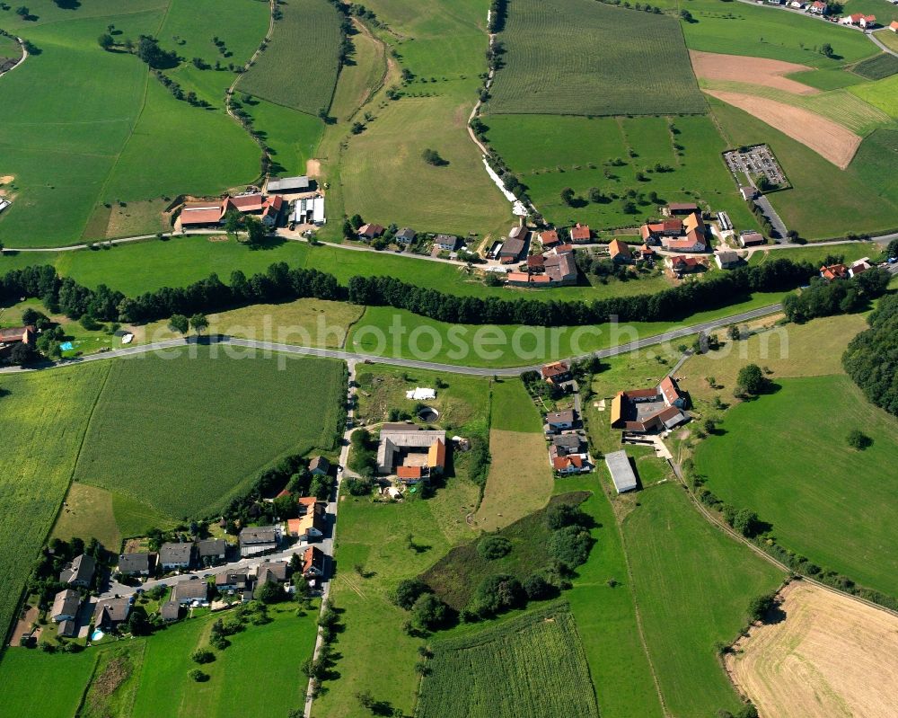 Aerial image Gumpen - Agricultural land and field boundaries surround the settlement area of the village in Gumpen in the state Hesse, Germany