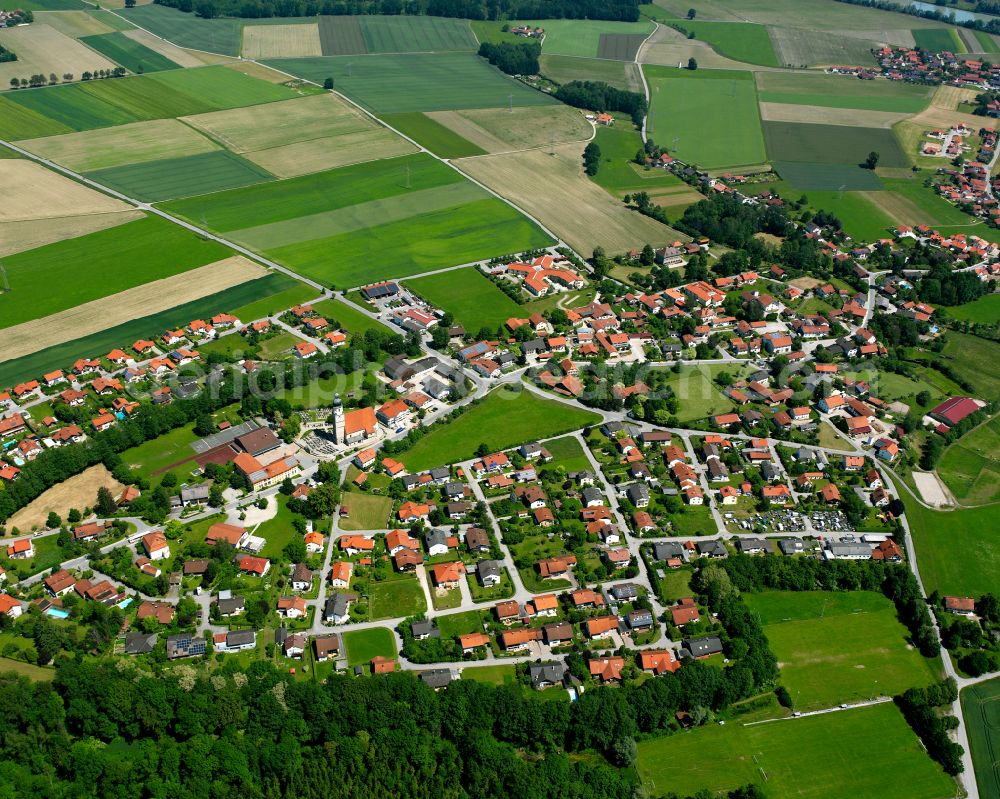 Haiming from the bird's eye view: Agricultural land and field boundaries surround the settlement area of the village in Haiming in the state Bavaria, Germany