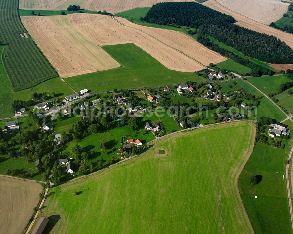 Hartha from the bird's eye view: Agricultural land and field boundaries surround the settlement area of the village in Hartha in the state Saxony, Germany