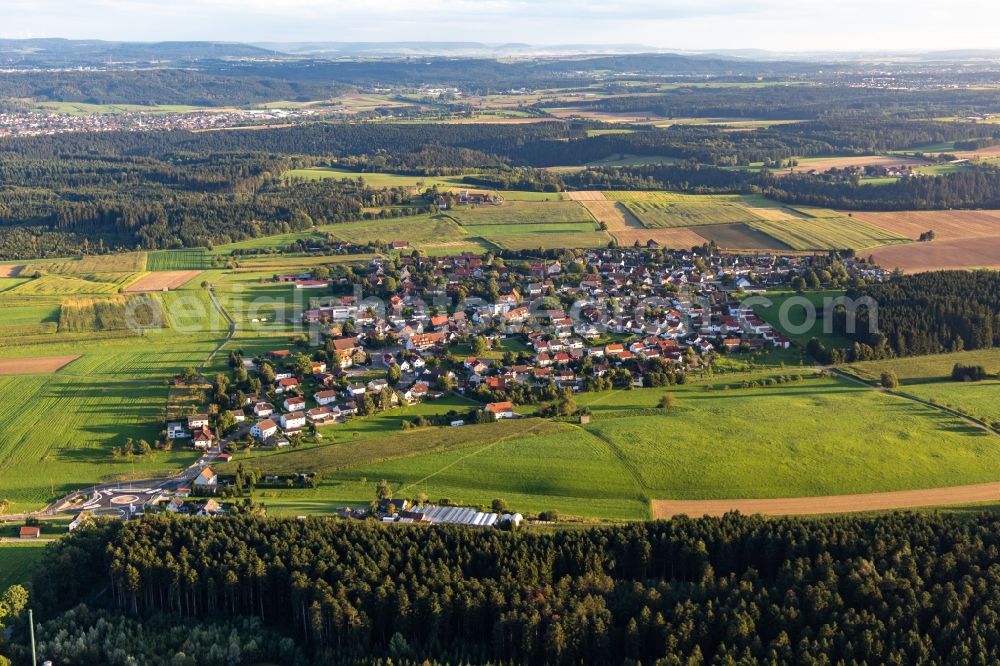 Hausen ob Rottweil from the bird's eye view: Agricultural land and field boundaries surround the settlement area of the village in Hausen ob Rottweil in the state Baden-Wuerttemberg, Germany