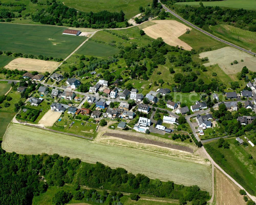 Aerial photograph Hübingen - Agricultural land and field boundaries surround the settlement area of the village in Hübingen in the state Rhineland-Palatinate, Germany