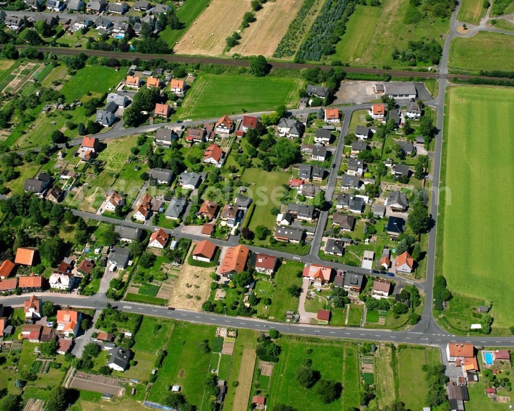 Aerial image Hedemünden - Agricultural land and field boundaries surround the settlement area of the village in Hedemünden in the state Lower Saxony, Germany