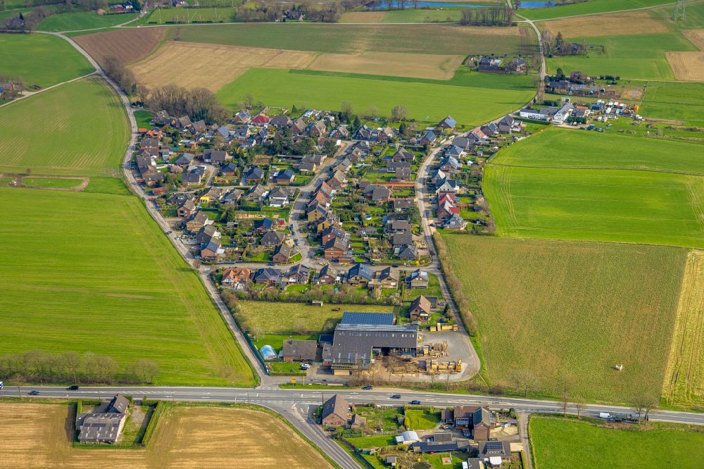 Aerial image Heelden - Agricultural land and field boundaries surround the settlement area of the village in Heelden in the state North Rhine-Westphalia, Germany