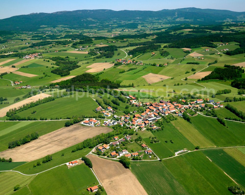 Heindlschlag from above - Agricultural land and field boundaries surround the settlement area of the village in Heindlschlag in the state Bavaria, Germany