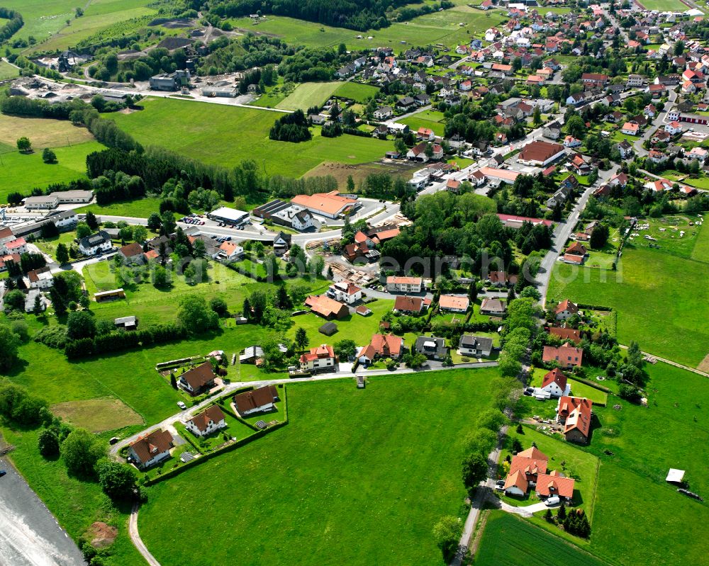 Herbstein from the bird's eye view: Agricultural land and field boundaries surround the settlement area of the village in Herbstein in the state Hesse, Germany
