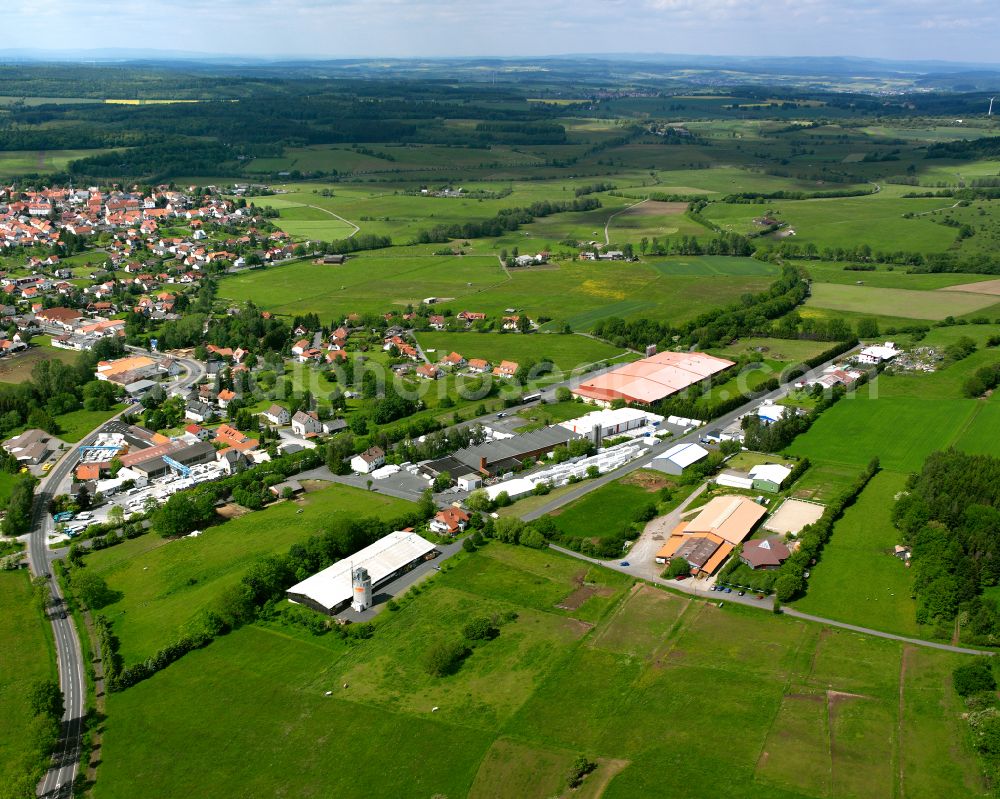 Aerial image Herbstein - Agricultural land and field boundaries surround the settlement area of the village in Herbstein in the state Hesse, Germany