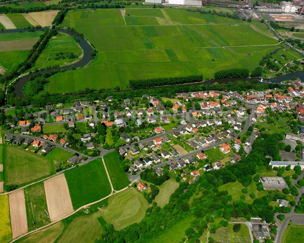 Heringen (Werra) from the bird's eye view: Agricultural land and field boundaries surround the settlement area of the village in Heringen (Werra) in the state Hesse, Germany