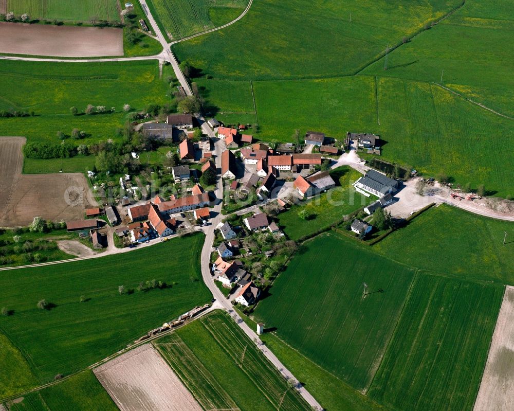 Höfen from above - Agricultural land and field boundaries surround the settlement area of the village in Höfen in the state Bavaria, Germany