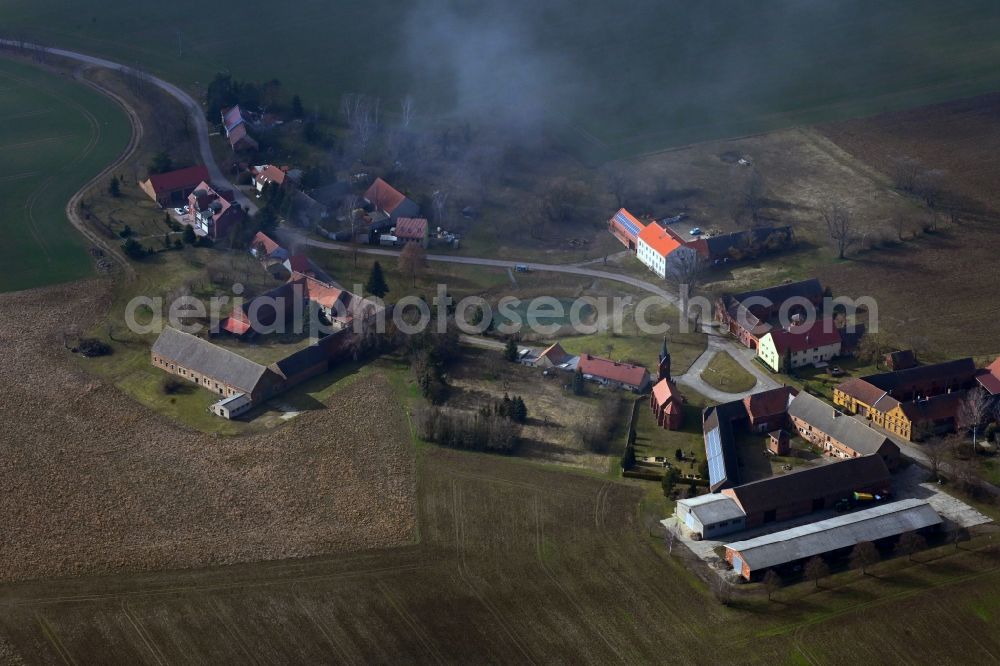 Höfgen from the bird's eye view: Agricultural land and field boundaries surround the settlement area of the village in Hoefgen in the state Brandenburg, Germany