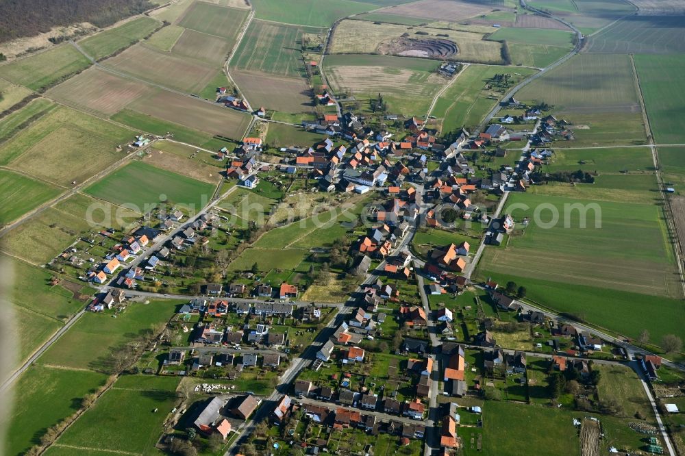 Aerial image Hilwartshausen - Agricultural land and field boundaries surround the settlement area of the village in Hilwartshausen in the state Lower Saxony, Germany