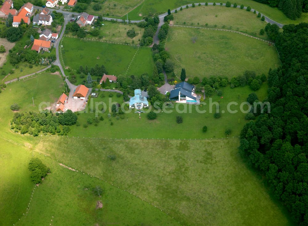 Hintersteinerhof from above - Agricultural land and field boundaries surround the settlement area of the village in Hintersteinerhof in the state Rhineland-Palatinate, Germany