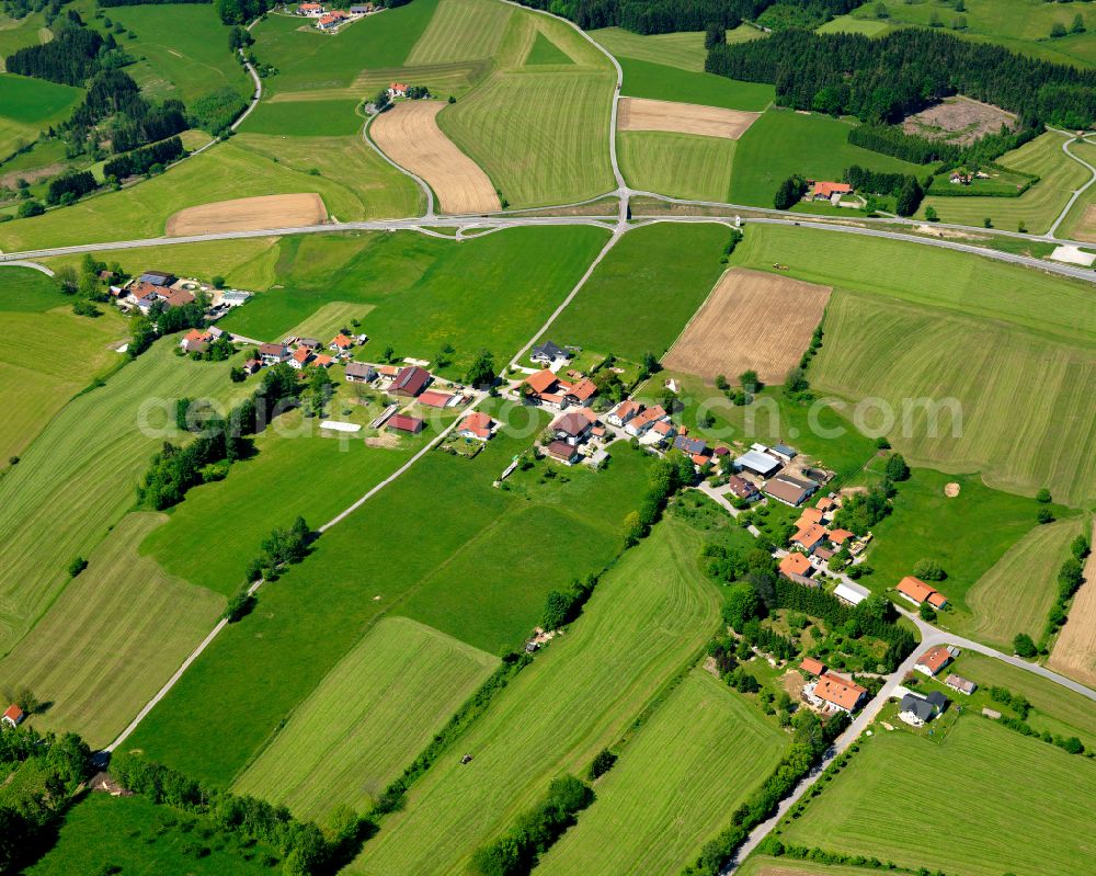 Hinterwollaberg from above - Agricultural land and field boundaries surround the settlement area of the village in Hinterwollaberg in the state Bavaria, Germany
