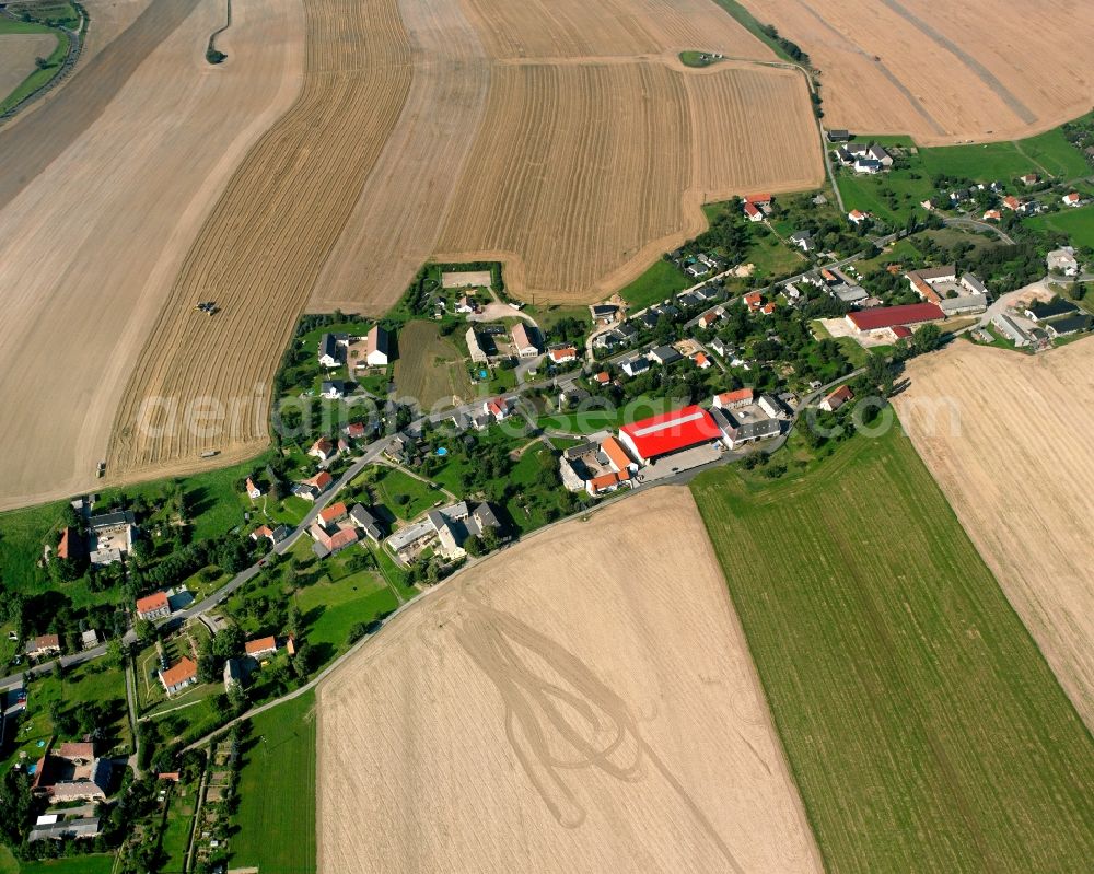 Hirschfeld from above - Agricultural land and field boundaries surround the settlement area of the village in Hirschfeld in the state Saxony, Germany