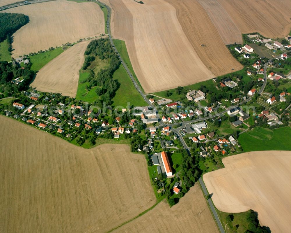 Hirschfeld from the bird's eye view: Agricultural land and field boundaries surround the settlement area of the village in Hirschfeld in the state Saxony, Germany
