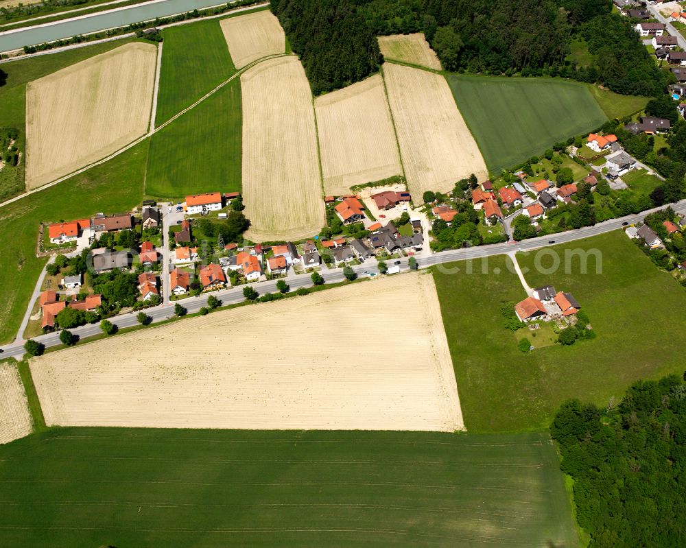 Hölzling from above - Agricultural land and field boundaries surround the settlement area of the village in Hölzling in the state Bavaria, Germany