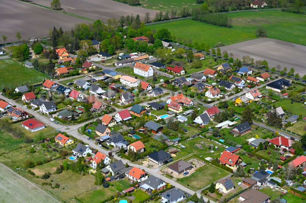 Hohenbruch from above - Agricultural land and field boundaries surround the settlement area of the village in Hohenbruch in the state Brandenburg, Germany