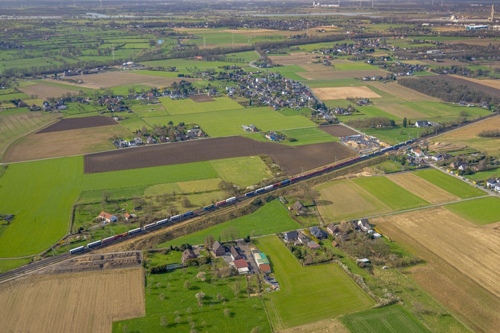 Holthausen from the bird's eye view: Agricultural land and field boundaries surround the settlement area of the village in Holthausen in the state North Rhine-Westphalia, Germany