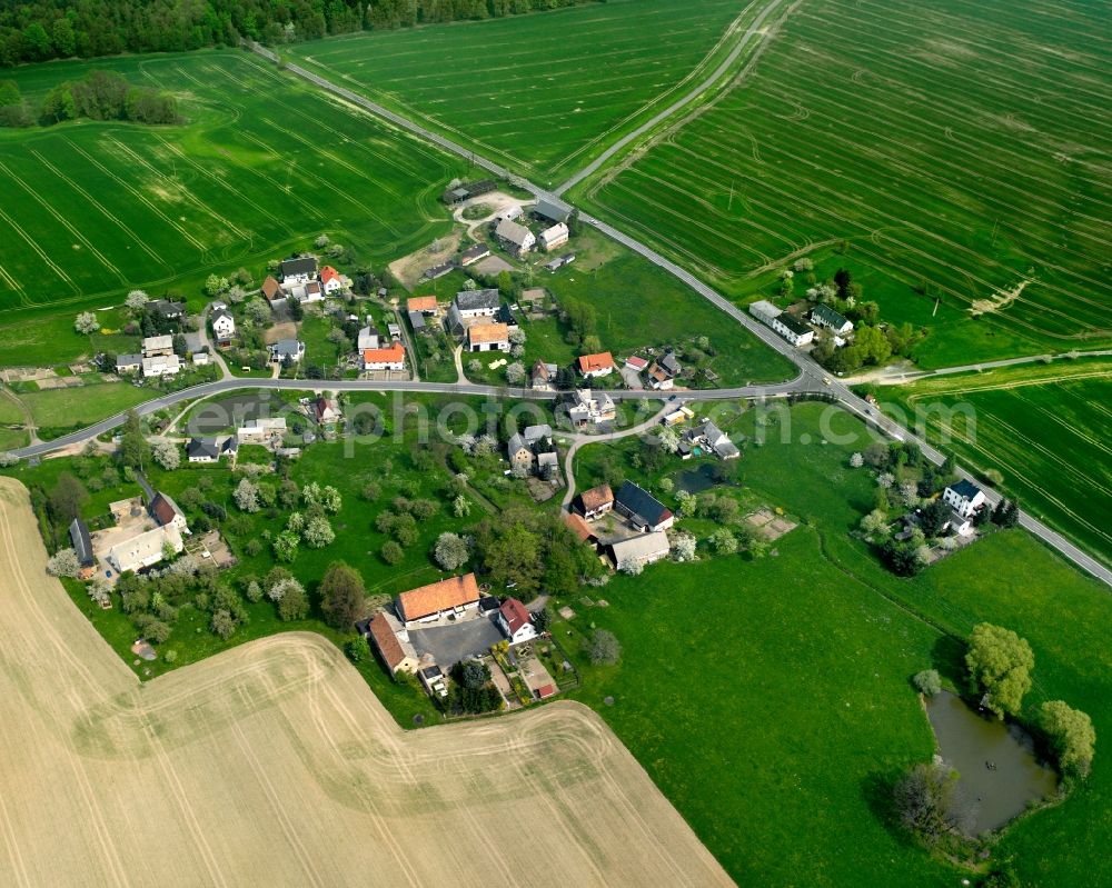 Hoyersdorf from the bird's eye view: Agricultural land and field boundaries surround the settlement area of the village in Hoyersdorf in the state Saxony, Germany
